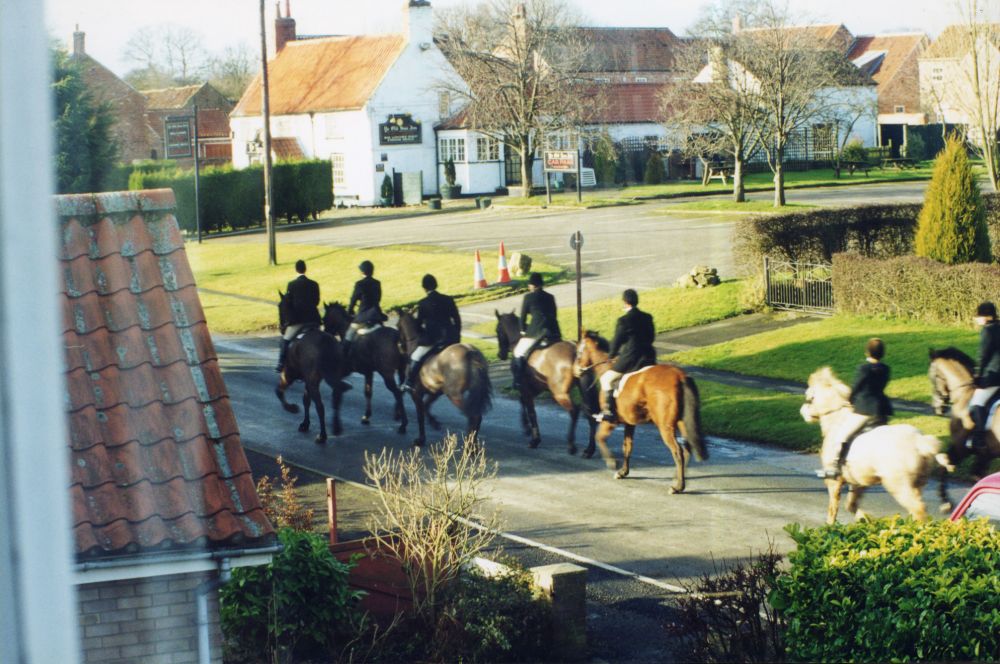 Horses and riders near Ye Old Sun Inn